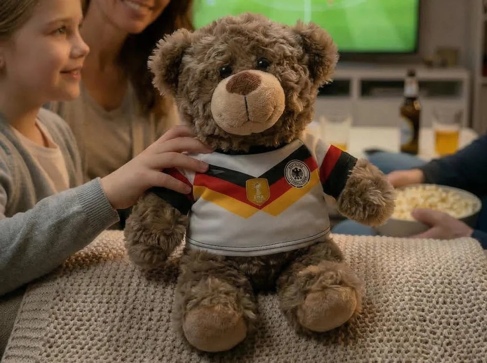 ein kuscheltier mit einem wm2026 fantrikot. man kann name und nummer kostenfrei individualisieren lassen